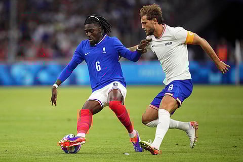 Manu Kone and Tanner Tessmann battle for a head ball